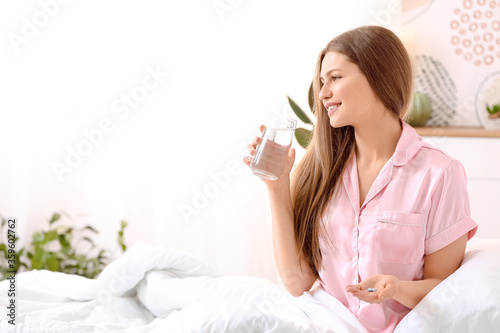 Young woman taking sleeping...