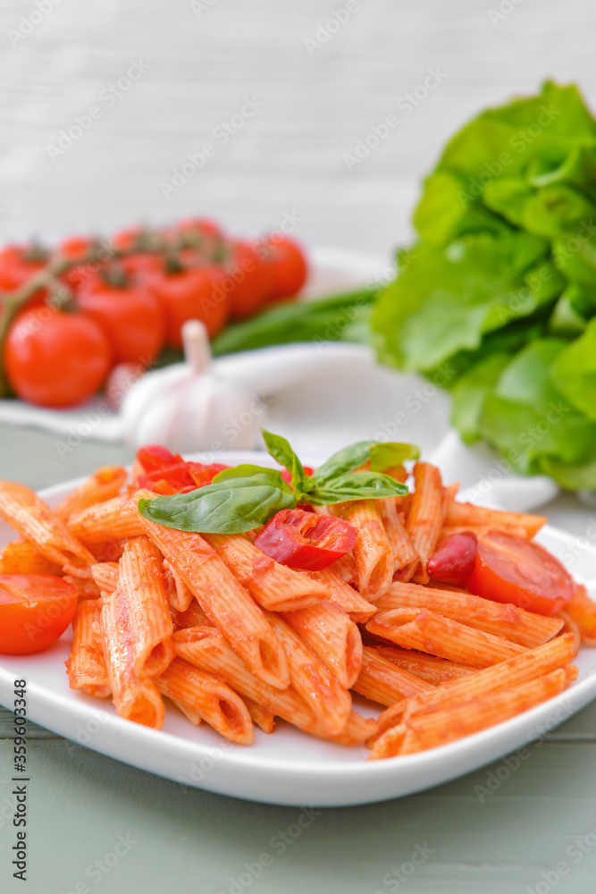 Plate with tasty pasta and tomato sauce on table Plate with tasty pasta and tomato sauce on table