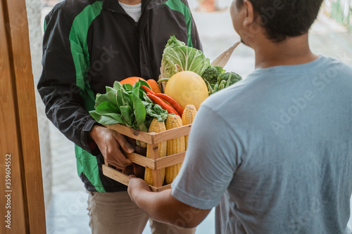 Canvas Print grocery online shopping. asian man delivering food to customer