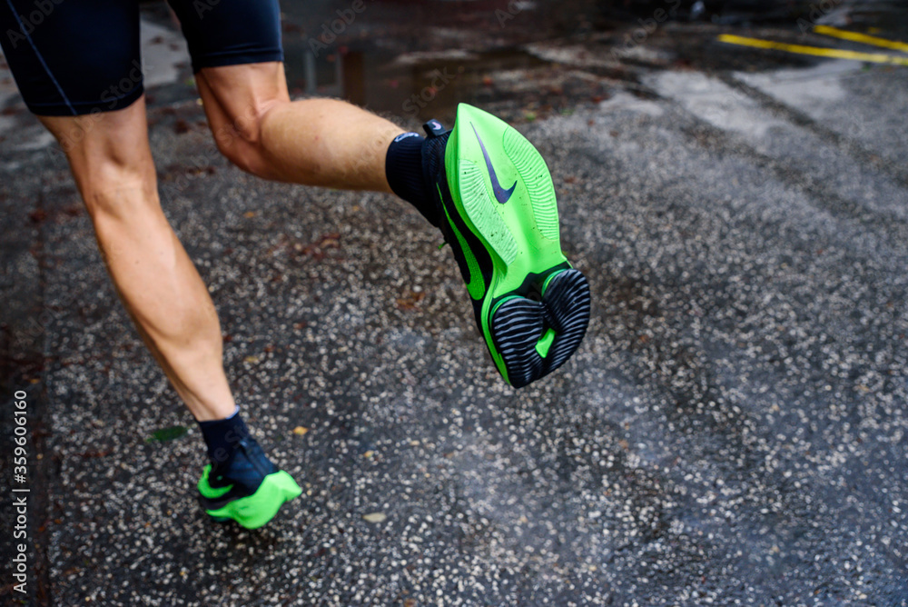 ROME, ITALY, JUNE 23. 2020: Nike running shoes ALPHAFLY NEXT%.  Controversial green athletics shoe on legs of professional athlete running  on the road. Official shoe for Tokyo Olympics 2020 marathon Stock Photo |  Adobe Stock