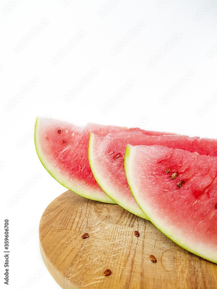 Bright juicy red watermelon cut into slices on a white background. Space for text.