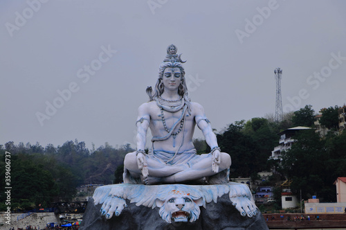 RISHIKESH, INDIA , Statue of Shiva, Hindu idol near Ganges River water, Rishikesh, India. The first Hindu God Shiva. Sacred places for pilgrims in Rishikesh