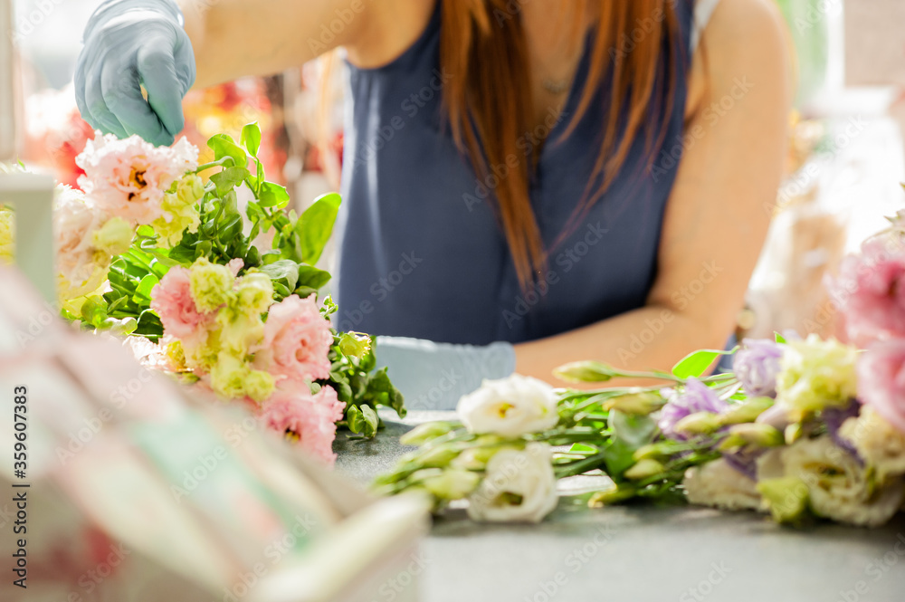 The florist works with flowers. Make a Bouquet of eustoma. Florist at work. Florist's workplace. The florist works in gloves. Small business in a pandemic. The florist works with flowers. Make a Bouquet of eustoma. Florist at work. Florist's workplace. The florist works in gloves. Small business in a pandemic.