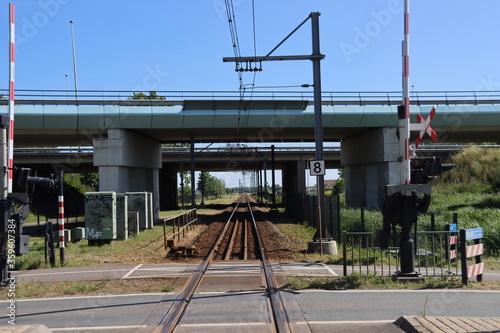 Single railroad track between Gouda and Alphen at rail road crossing at Waddinxveen for R-NET train. photo