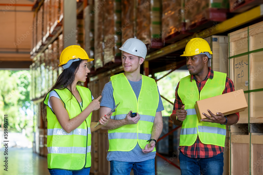 Warehouse manager and foreman working together in a large warehouse Warehouse manager and foreman working together in a large warehouse