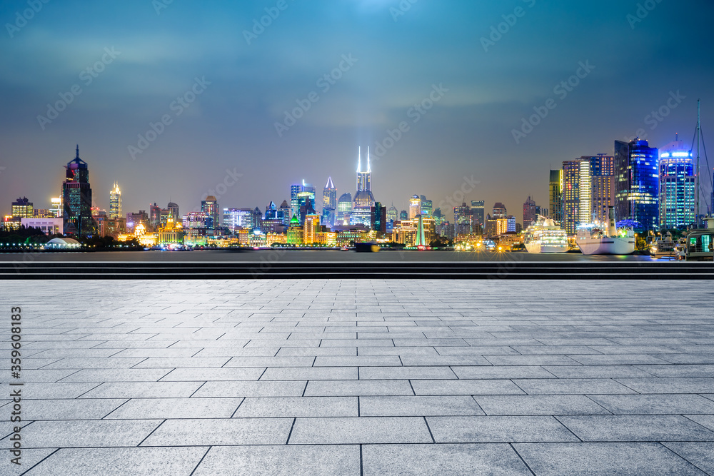 Empty square floor and modern city scenery at night in Shanghai,China.