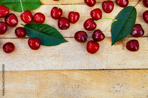 Ripe sweet cherries on a wooden background.