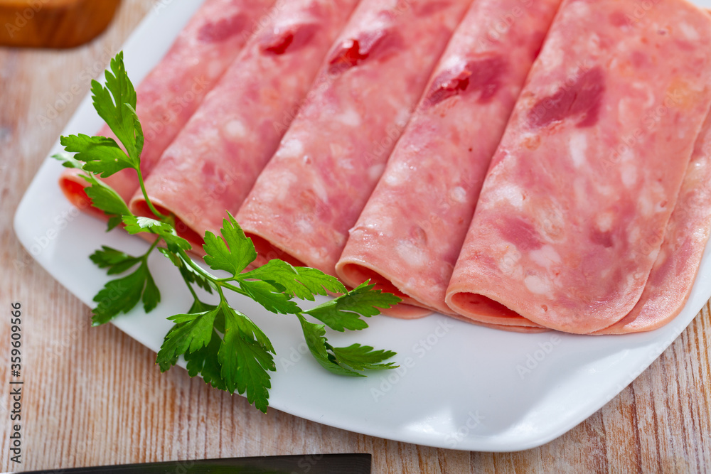 Closeup of sliced tasty ham on plate