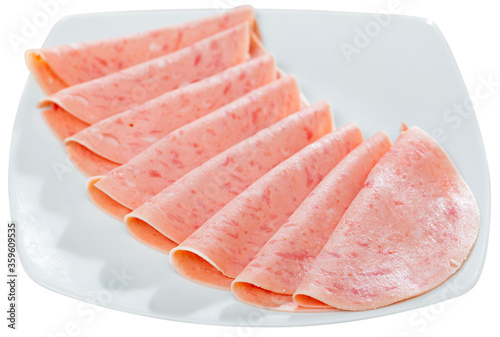 Closeup of sliced tasty ham on plate