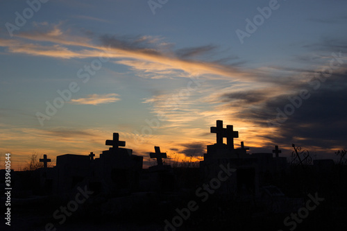cross tomb cemetery silhouette at sunset