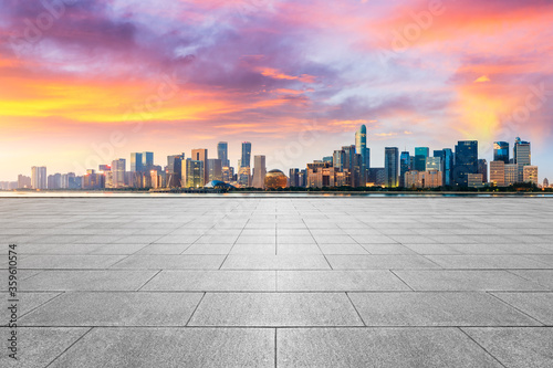 Empty square floor and modern city scenery at sunrise in Hangzhou,China.