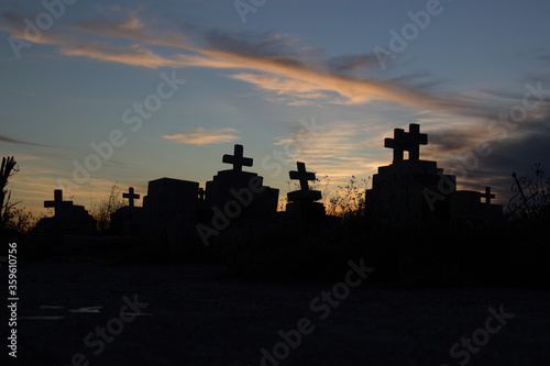 cross tomb cemetery silhouette at sunset
