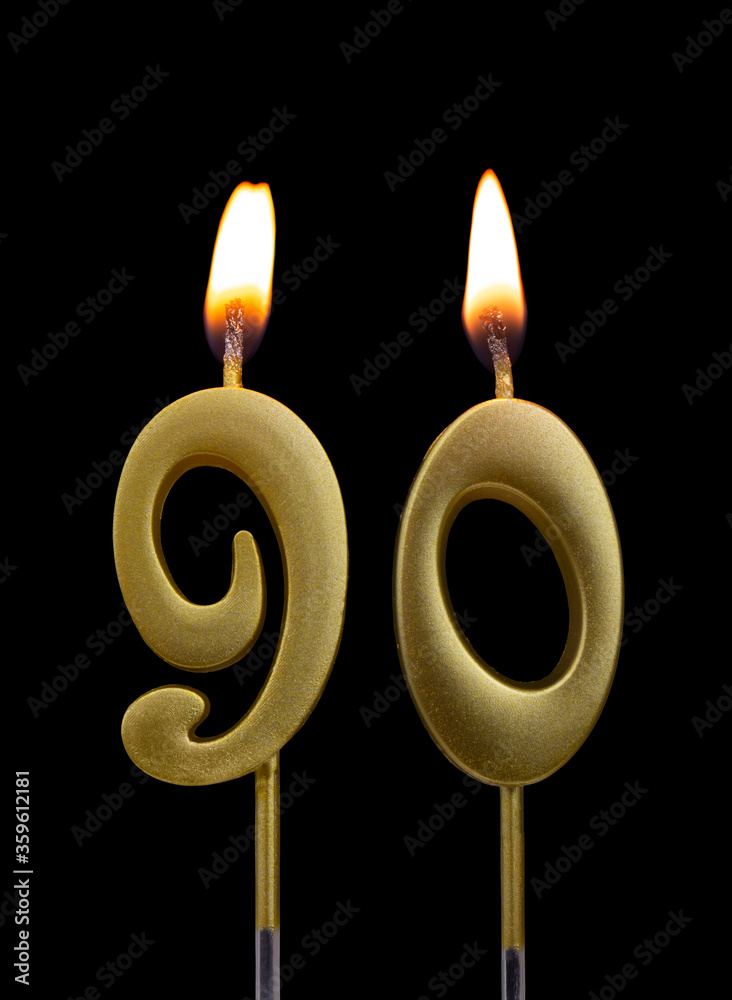 Burning golden birthday candles isolated on black background, number 90 Burning golden birthday candles isolated on black background, number 90