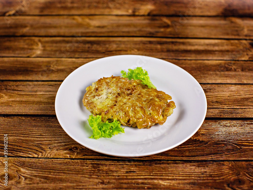 Grilled meat with green salad on a white plate