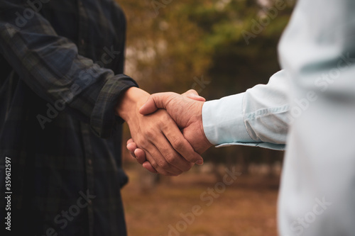People shake hand greeting teamwork partnership friendship outdoor community
