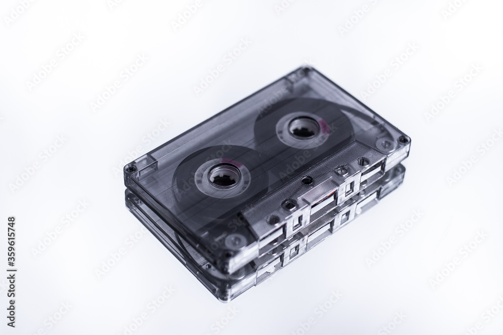 Obraz premium old audio tape on a white background with a reflection in the mirror