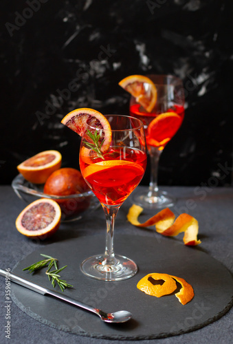 Blood orange cocktail in glasses on dark background. Copy space