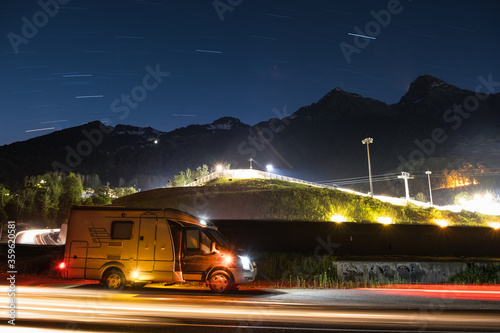 фотографія house on wheels in the mountains at night