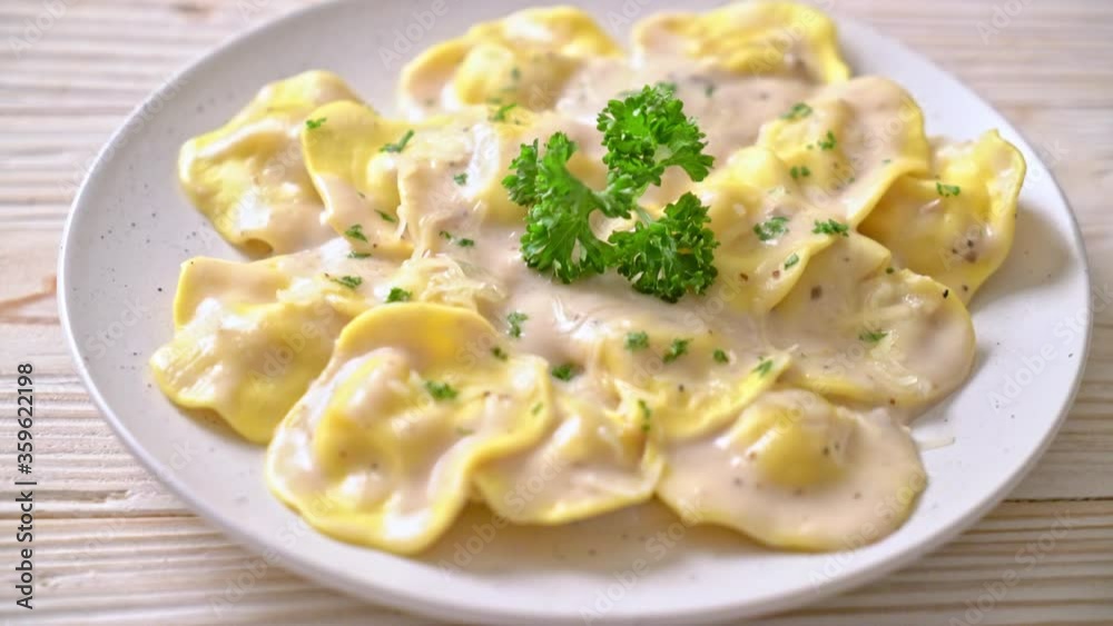 ravioli pasta with mushroom cream sauce and cheese - Italian food style ravioli pasta with mushroom cream sauce and cheese - Italian food style