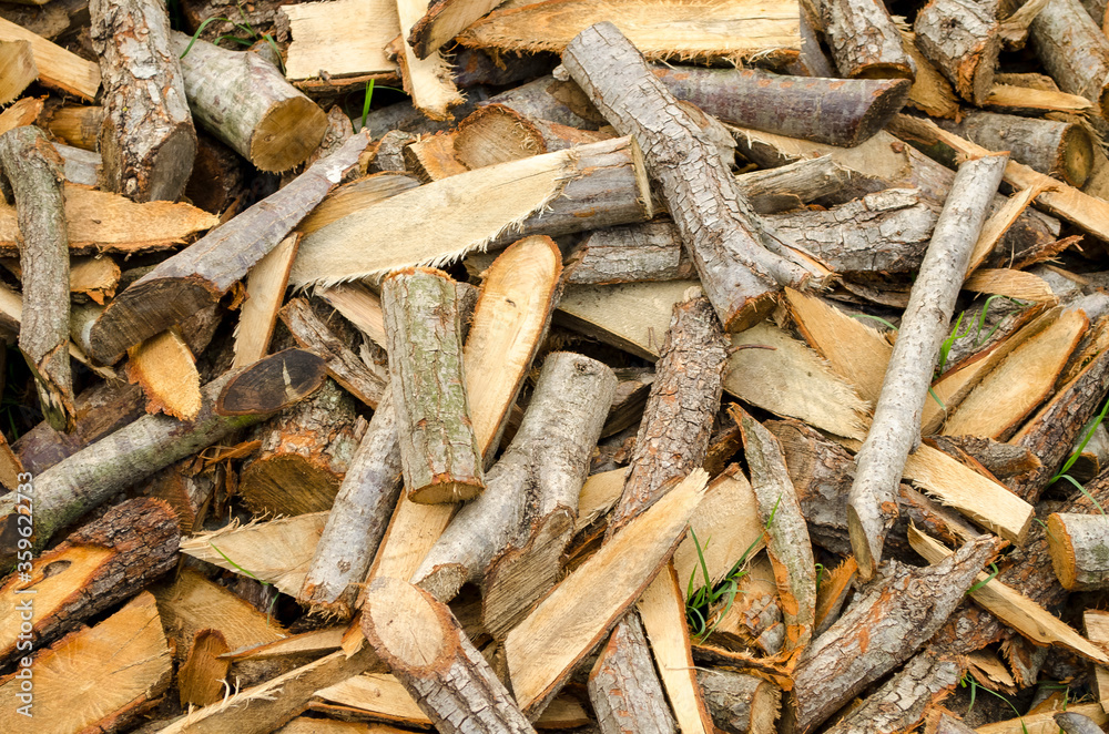 Chopped wood for the fireplace close-up. Wooden logs. Autumn natural background. Copy space. Selective focus image. Chopped wood for the fireplace close-up. Wooden logs. Autumn natural background. Copy space. Selective focus image.
