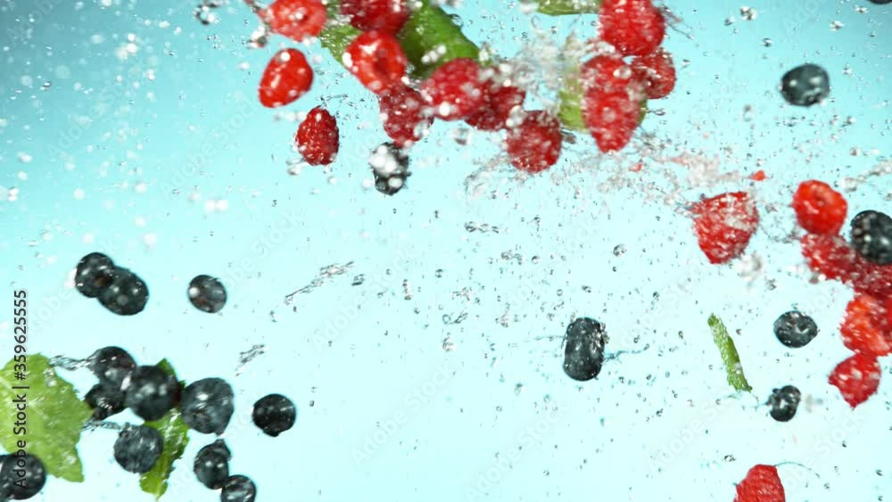 Slow motion of raspberries and blueberries flying in the air, water splashes. Filmed on high speed cinema camera, 1000 fps. Slow motion of raspberries and blueberries flying in the air, water splashes. Filmed on high speed cinema camera, 1000 fps.