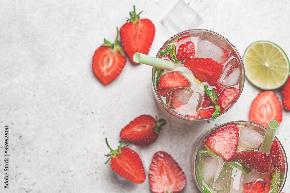 Detox sassy water with strawberries and lime in glasses, top view. Healthy eating concept. Detox sassy water with strawberries and lime in glasses, top view. Healthy eating concept.