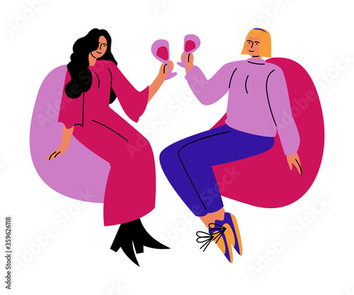 A happy lesbian couple of women drinks wine from glasses sitting on chairs. Vector illustration in cartoon style.