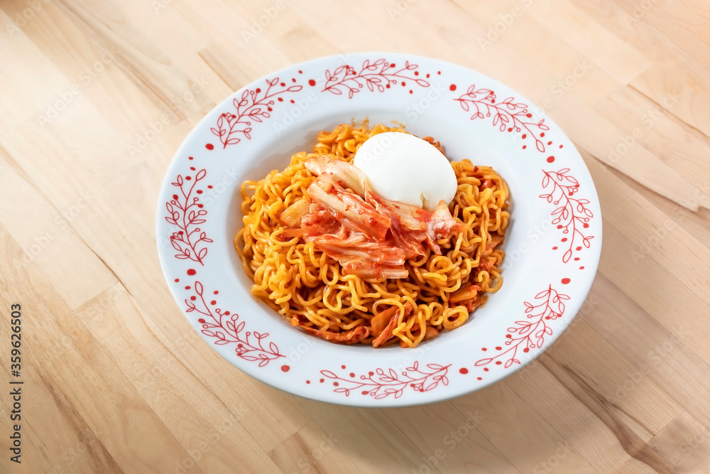 close up of kimchi ramyeon with a hard boiled egg close up of kimchi ramyeon with a hard boiled egg