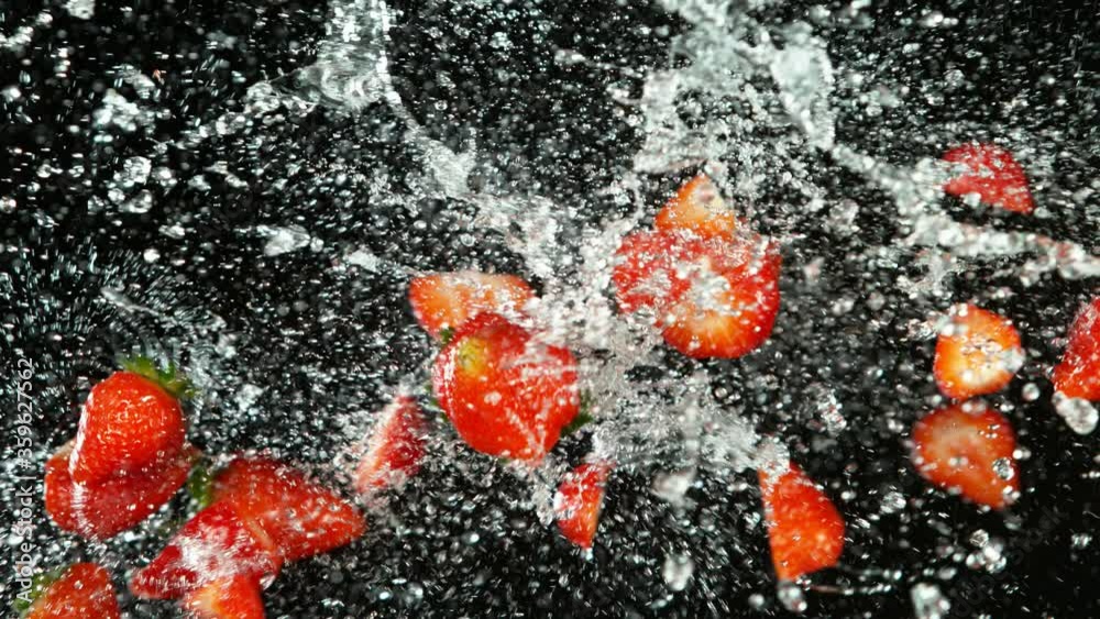 Super slow motion of strawberries flying up in the air with water splashes. Filmed on high speed cinema camera, 1000 fps. Super slow motion of strawberries flying up in the air with water splashes. Filmed on high speed cinema camera, 1000 fps.