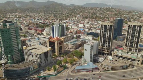 Descending aerial view of the amazing coastline city of Port of Spain, Trinidad photo