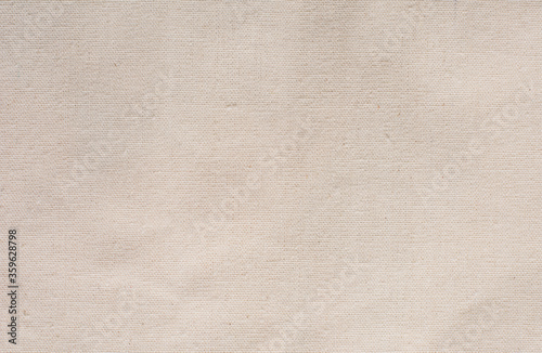 Light beige fabric texture. Burlap. Light rough fabric background.