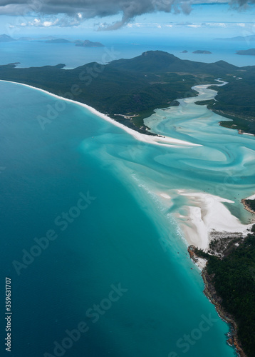 Beautiful aerial view of turquoise water, white sandy beaches and green forests in the tropical wonder of the Whitsundays islands, Queensland, Australia. Concept for summer, travelling and vacation photo