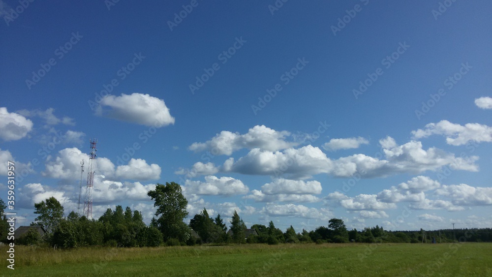 Green field and blue sky with white clouds in the countryside Green field and blue sky with white clouds in the countryside