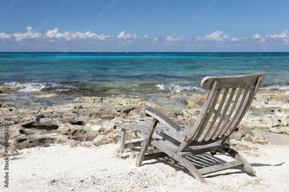 Empty wood chair on the beautiful beach in Caribbean sea