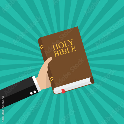 Hand holding holy bible