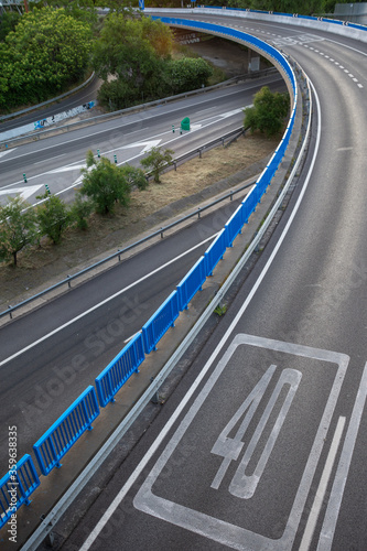 View of access curve to M30 with 40 km limit, empty, at sunset, in Madrid, Spain, vertically