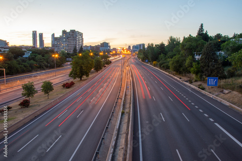 Panoramic view of M30 motorway, at sunset, with red trails of car lights, in Madrid, Spain, horizontal