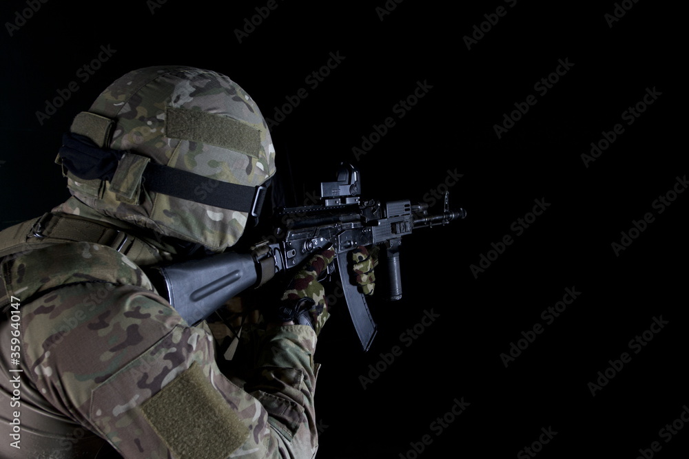 Dissolving SWAT soldier back view. swat soldier back view posing with a dissolving effect on a black background.
