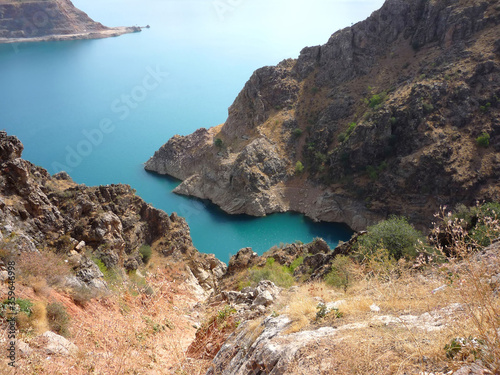 Beautiful lake Charvak in Uzbekistan with clear blue water. A view of the lake from the mountain.