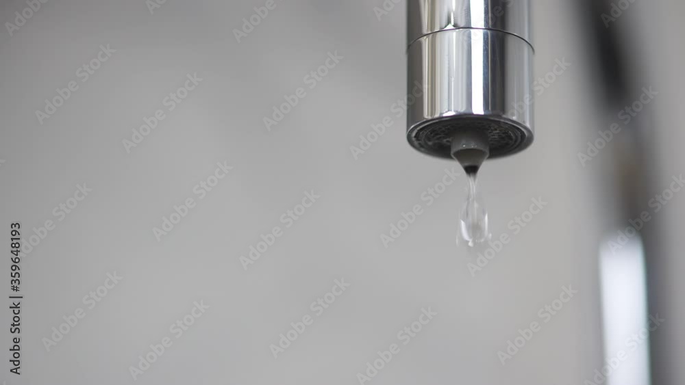 Kitchen faucet with dripping water, close-up. Leaky plumbing faucet. Water leak from the tap. Global problem of shortage of fresh water Kitchen faucet with dripping water, close-up. Leaky plumbing faucet. Water leak from the tap. Global problem of shortage of fresh water