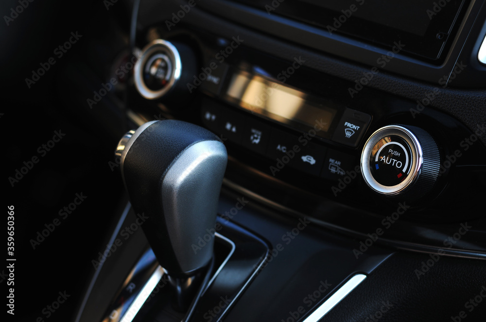Close up of the manual gearbox transmission handle. Accelerator handle and buttons in a new car.