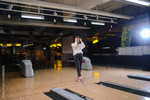 Beautiful caucasian woman on a bowling alley track