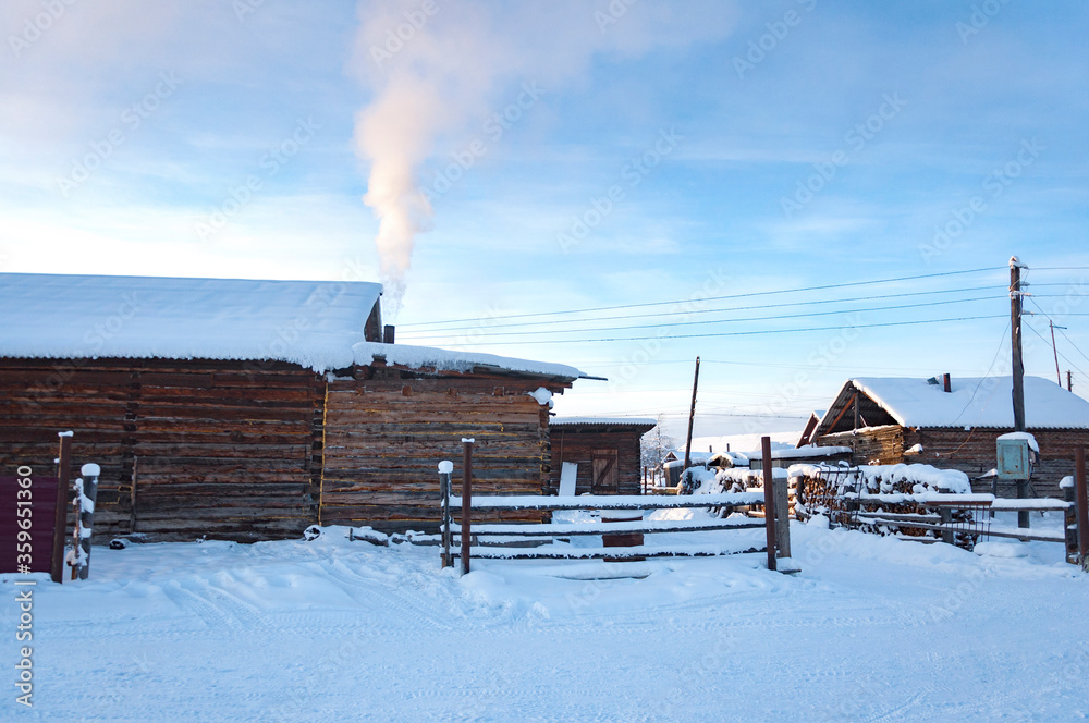 Winter landscape of the village Oymyakon with traditional wooden houses