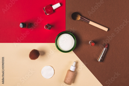 make up stuff on a brown red and cream color background