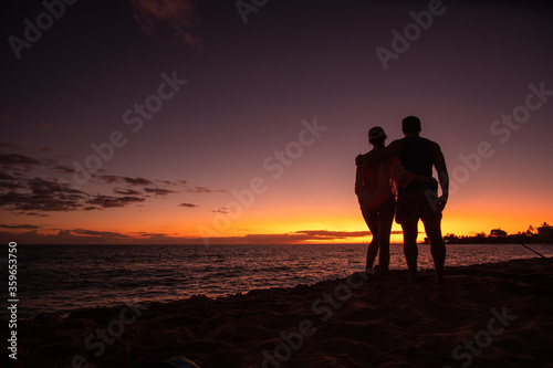 concept: romantic sunset as a pair in hawaii, perfect moment ,togetherness