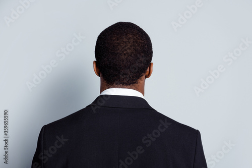 Back rear spine photo of anonym afro american company owner hide his face dont show wear good look tuxedo isolated over gray color background