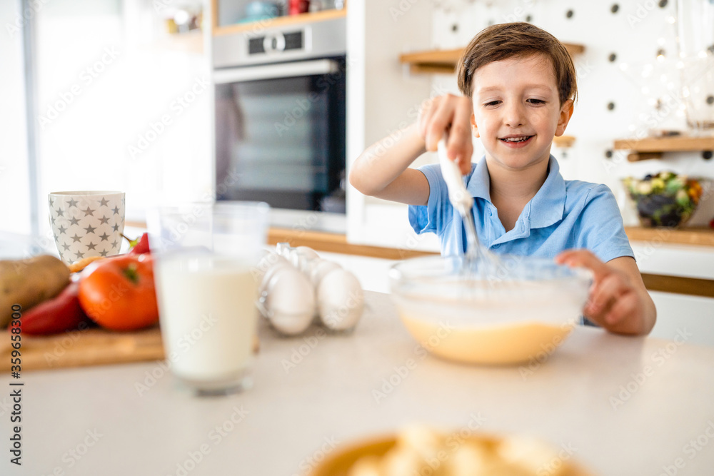 Happy beautiful kid learn preparing breakfast at home kitchen