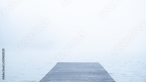 Fényképezés Concept of lonely wooden abandoned dock in fog