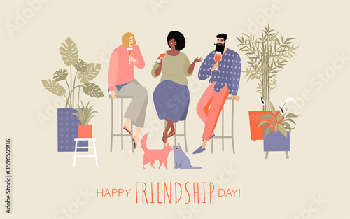 Happy friendship day. A group of friends spend time in a cafe, drinking cocktails and chatting and two funny cats sitting nearby