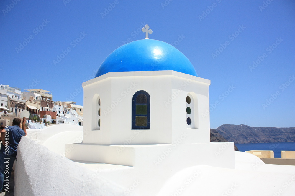 blue dome of a snow-white church on Santorini island blue dome of a snow-white church on Santorini island
